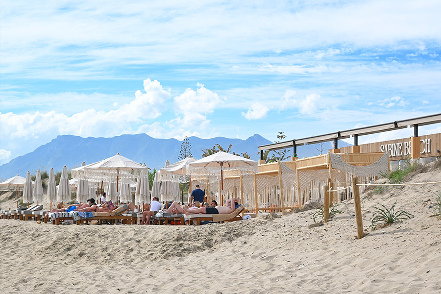 Sunbathers-enjoying-the-Sabine-Beach-club-at-Spain-best-beaches-Real-de-la-Zaragoza-near-the-mountains